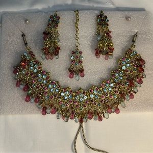 Beautiful pastel coloured jewellery set with necklace earrings and a head piece.